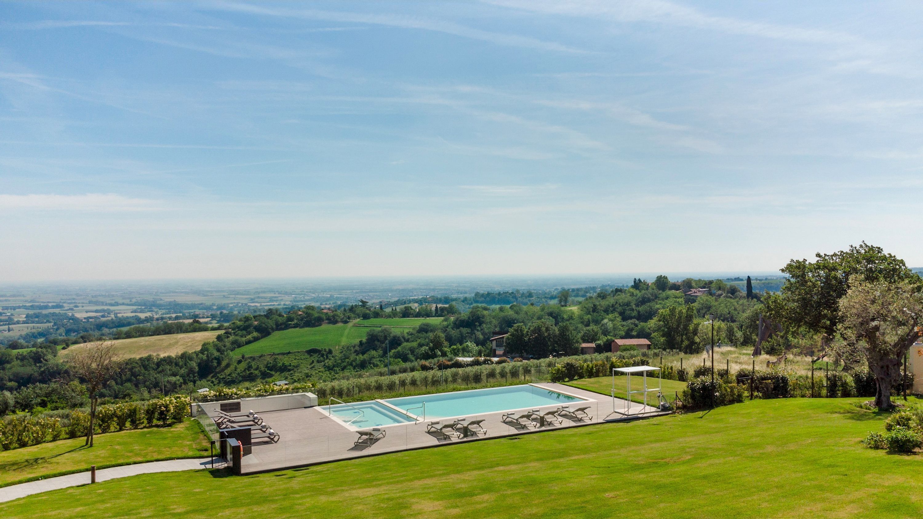 A pool area with a view of a distant landscape.