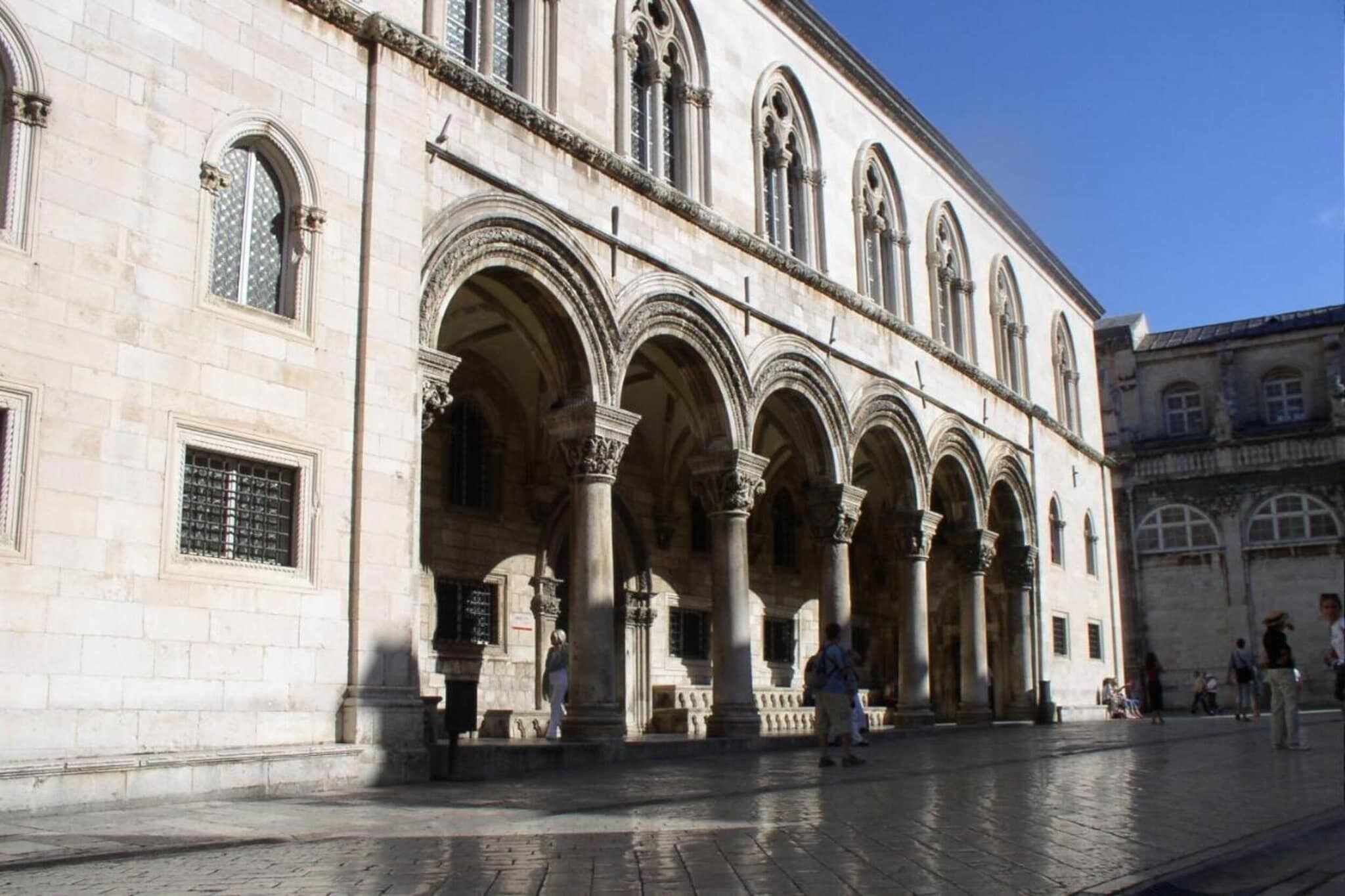 A historic building with arched windows and columns.