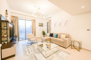 Deluxe Apartment | Living area | 50-inch Smart TV with cable channels - Yogi - Modern 2BR Apartment with Stunning Dubai Fountain (Dubai)