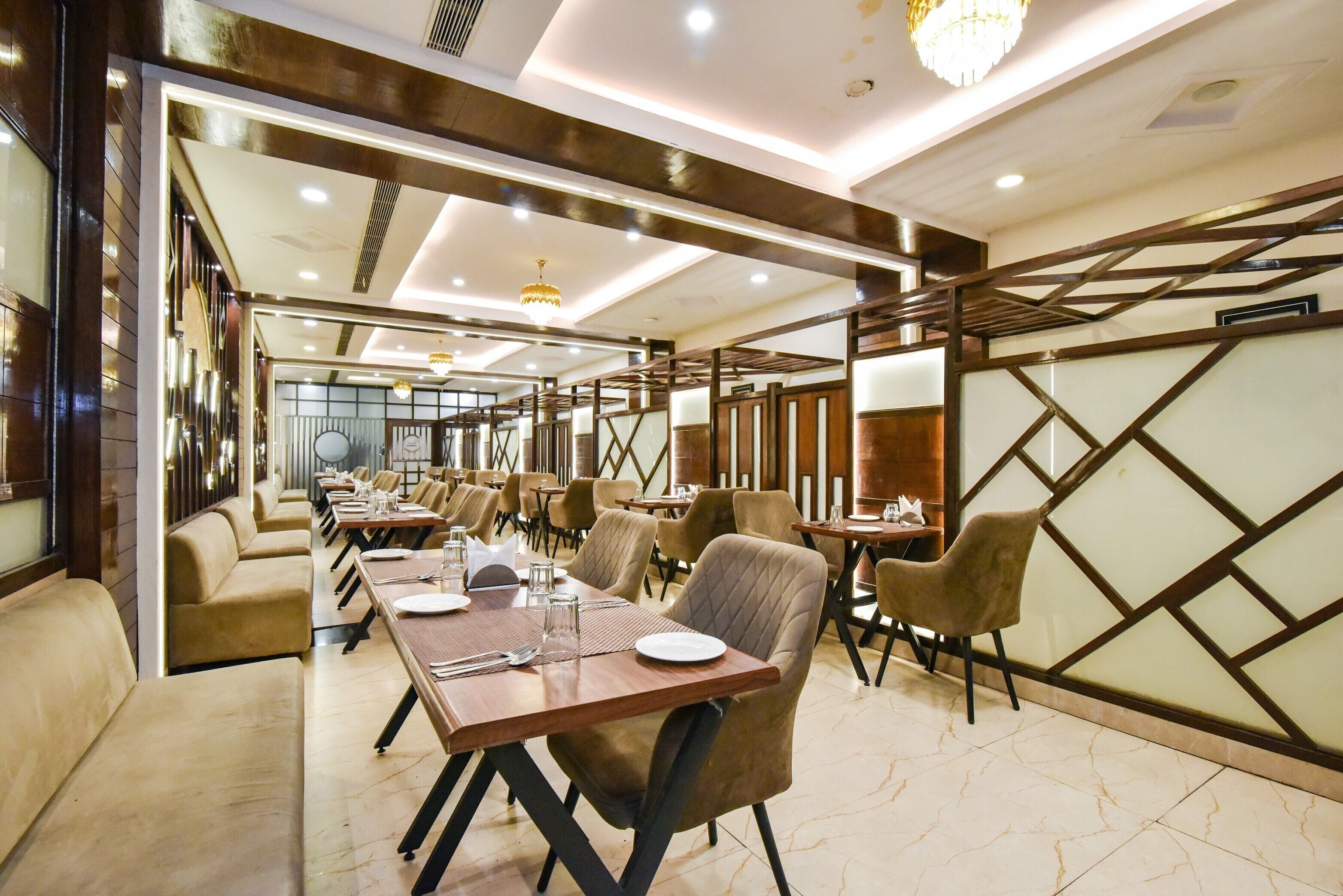 A hotel dining area with multiple tables, chairs, and a modern interior design.