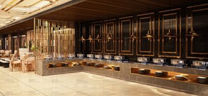 A modern hotel lobby with a marble floor, wooden paneling, and a buffet area with multiple serving stations. - NAT GRAND REGENCY (Ludhiana)