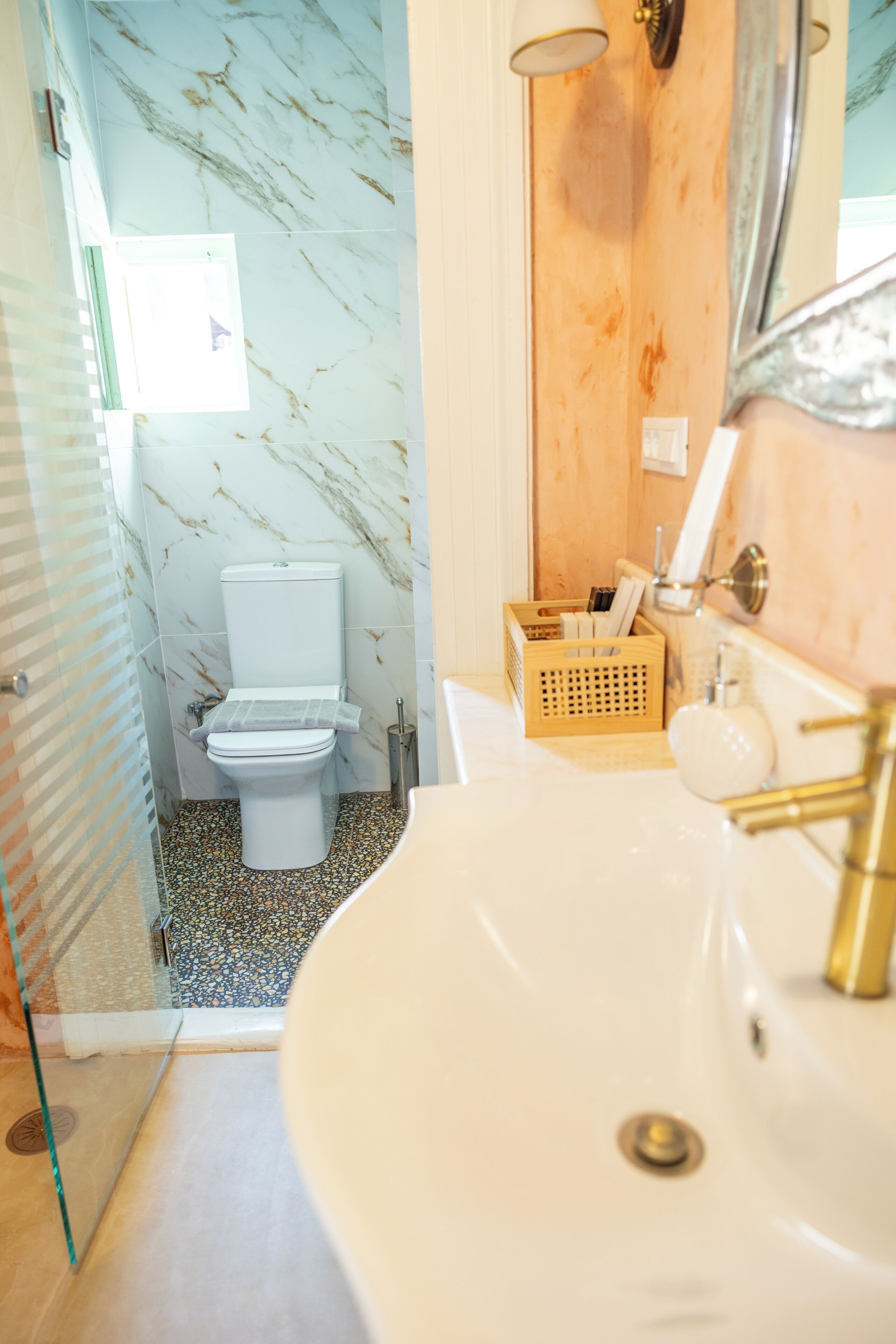 Un baño con inodoro, lavamanos y zona de ducha.