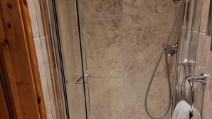 A glass-enclosed shower with a handheld showerhead and a towel rack. - Fab Studio Room in Botley, Oxford (Oxford)