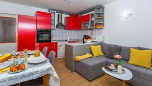 A compact living space with a kitchenette, a dining area, and a sofa. - Lovely apartment in Kraljevica (Kraljevica)
