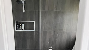 A modern bathroom with a shower, toilet, and a towel rack. - Ronny's Tootgarook. (Tootgarook)