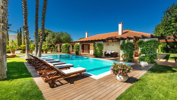 A pool with lounge chairs, a wooden deck, and a building with a tiled roof. - 3680 Villa Monica by Perle di Puglia (Polignano a Mare)