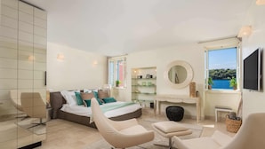 A modern bedroom with a bed, two chairs, a desk, a TV, and a large window with a view. - Natascha’s Beachfront/Stylish Two-Story Apartment A2 (Rovinj)
