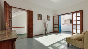 A spacious living room with a marble countertop, a beige sofa, and a large window allowing natural light. - 3678 A Casa di Vito by Barbarhouse (Salve)