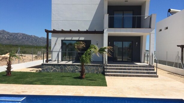 A modern two-story house with a swimming pool in the foreground.