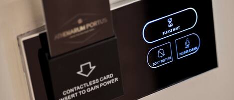 A digital display with instructions for using a contactless card to gain power, including options to wait, don't disturb, and clean.