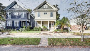 A two-story house with a front porch and a small garden area. - Stylish Home in Springfield Historic District! (Jacksonville)