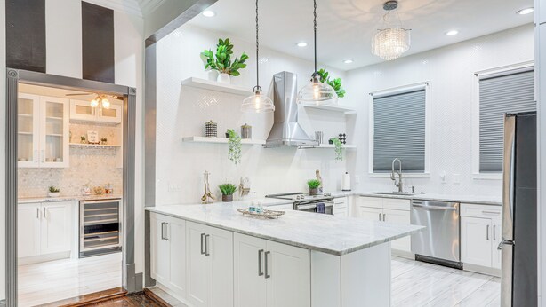 A modern kitchen with white cabinetry, stainless steel appliances, and pendant lighting. - Stylish Home in Springfield Historic District! (Jacksonville)