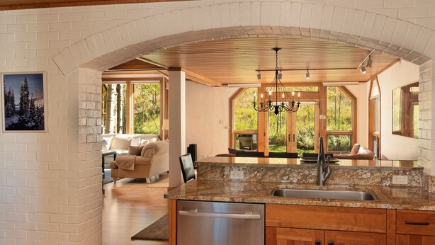 A kitchen with granite countertops, wooden cabinets, and a stainless steel dishwasher. - Townhome With Ski-in Access Near Pool And Spa by The Woodrun V Townhouses by RedAwning (Snowmass Village)