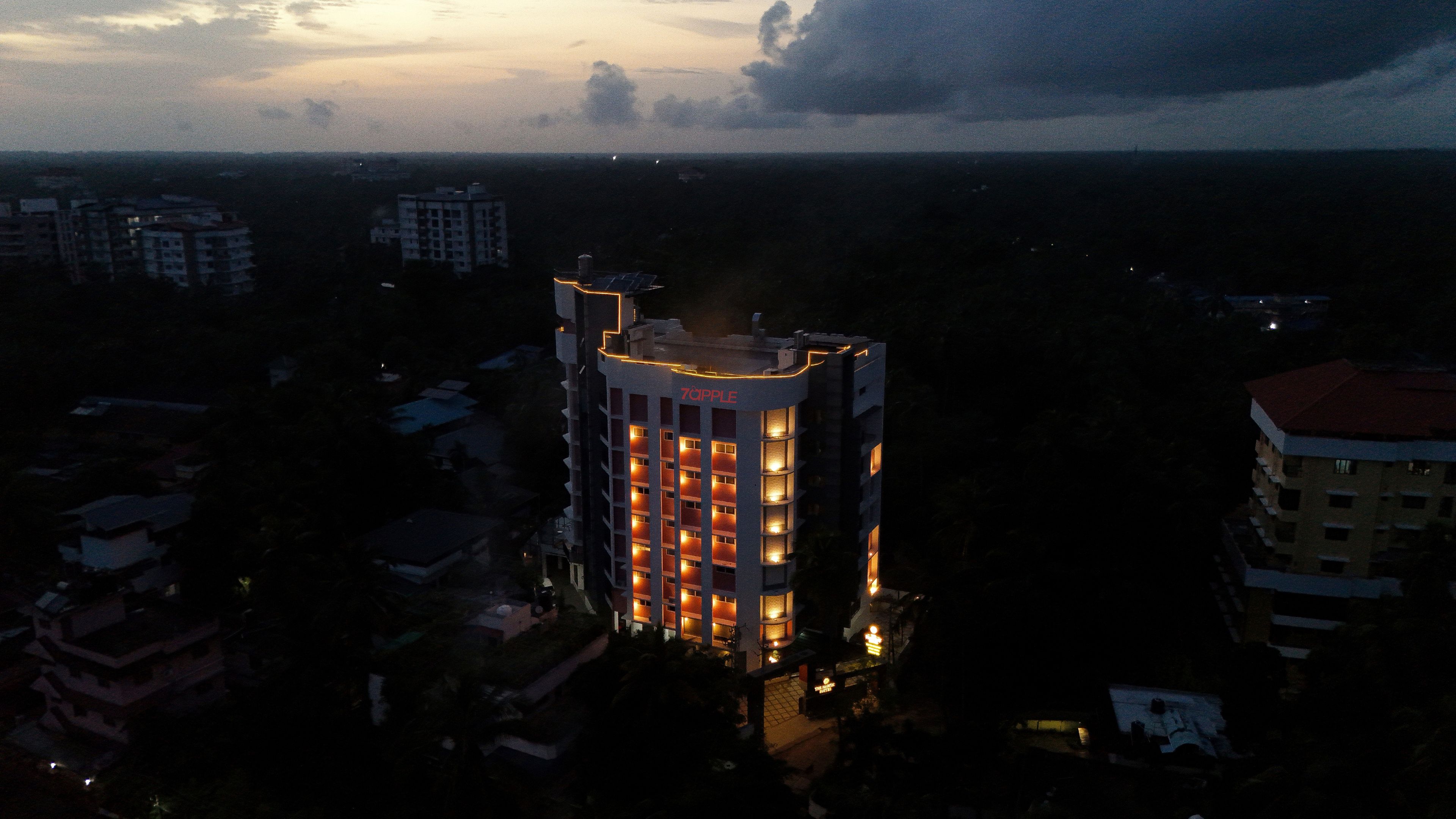 A multi-story hotel with a central atrium and illuminated windows.