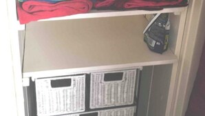 A closet with shelves holding folded clothes and storage bins. - Apartment Cosy annemasse (Annemasse)