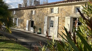 A stone building with a tiled roof, multiple doors, and windows. - Cottage 'La Cassine' with Shared Terrace, Shared Garden and Wi-Fi (Taillant)