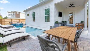 A two-story house with a pool, outdoor seating, and a covered patio. - Private Pool, LSV/Golf Cart, Bikes, BRAND NEW! Walk to Beach in Blue Mountain! (Santa Rosa Beach)
