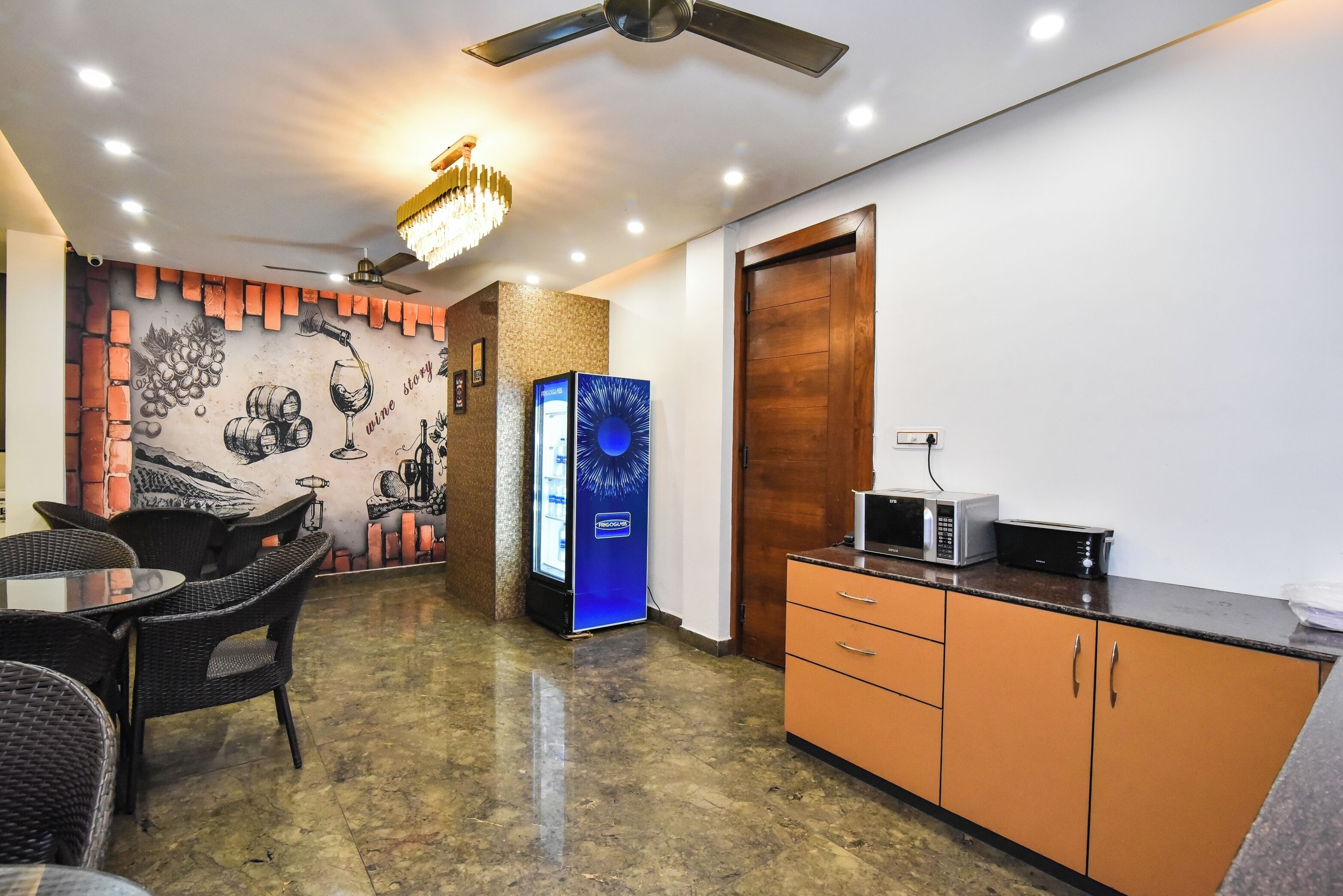 A modern kitchen with a microwave, a refrigerator, and a wooden cabinet.
