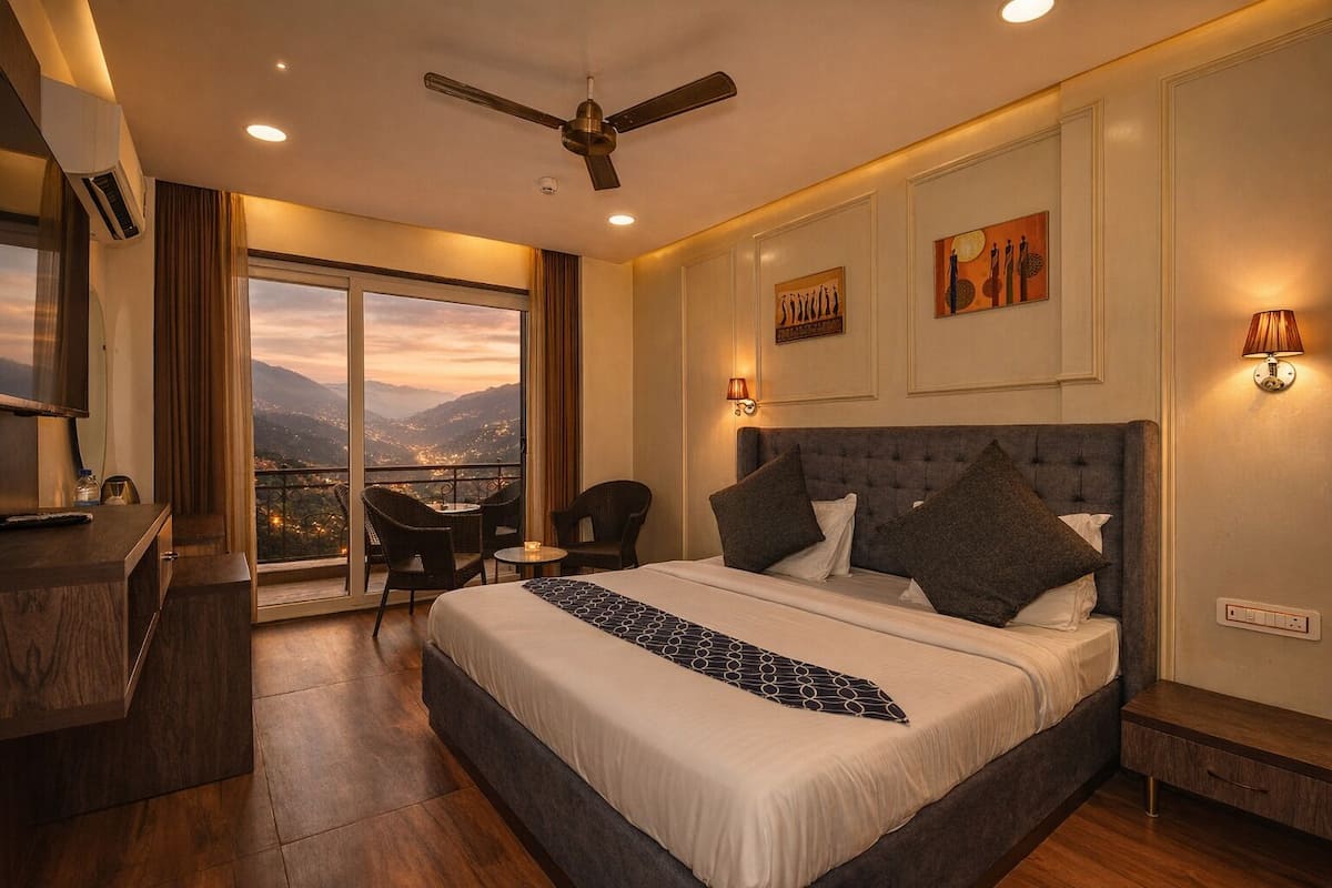 A hotel room with a large bed, a desk, a chair, and a balcony with a view of the mountains.