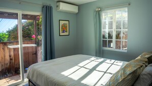 A bedroom with a bed, a window, and an air conditioning unit. - Relaxing Home With SF Bay View

 (Millbrae)