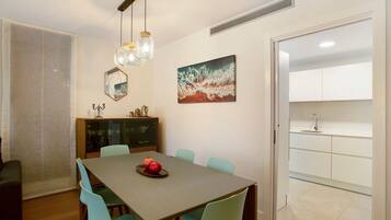 A dining area with a table, chairs, and a cabinet.