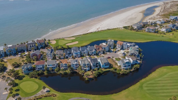 An aerial view of a coastal residential area with houses, a golf course, and a body of water. - Renovated, Golf cart included, pet friendly, club cards available - 326 Ocean Point (Fripp Island)