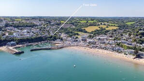 An aerial view of a coastal town with a marina, beach, and residential areas. - Four Oaks - Sea and Harbour Views (Saundersfoot)