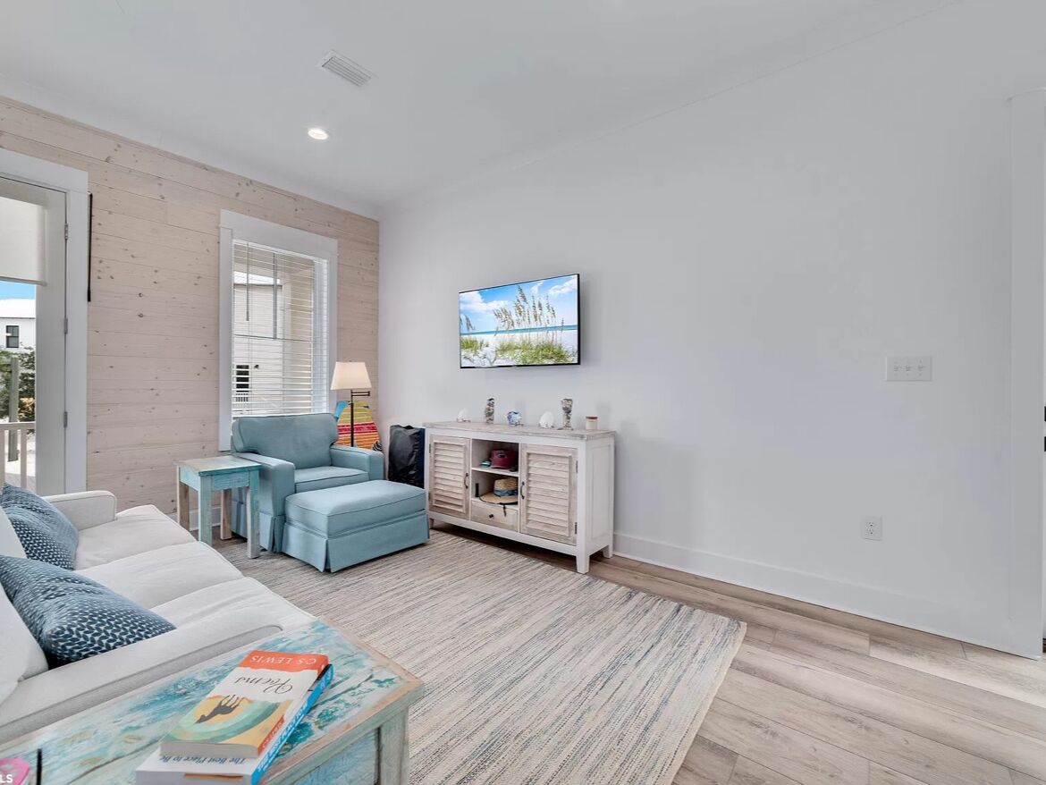 A modern living room with a sofa, a coffee table, a side table, and a cabinet.