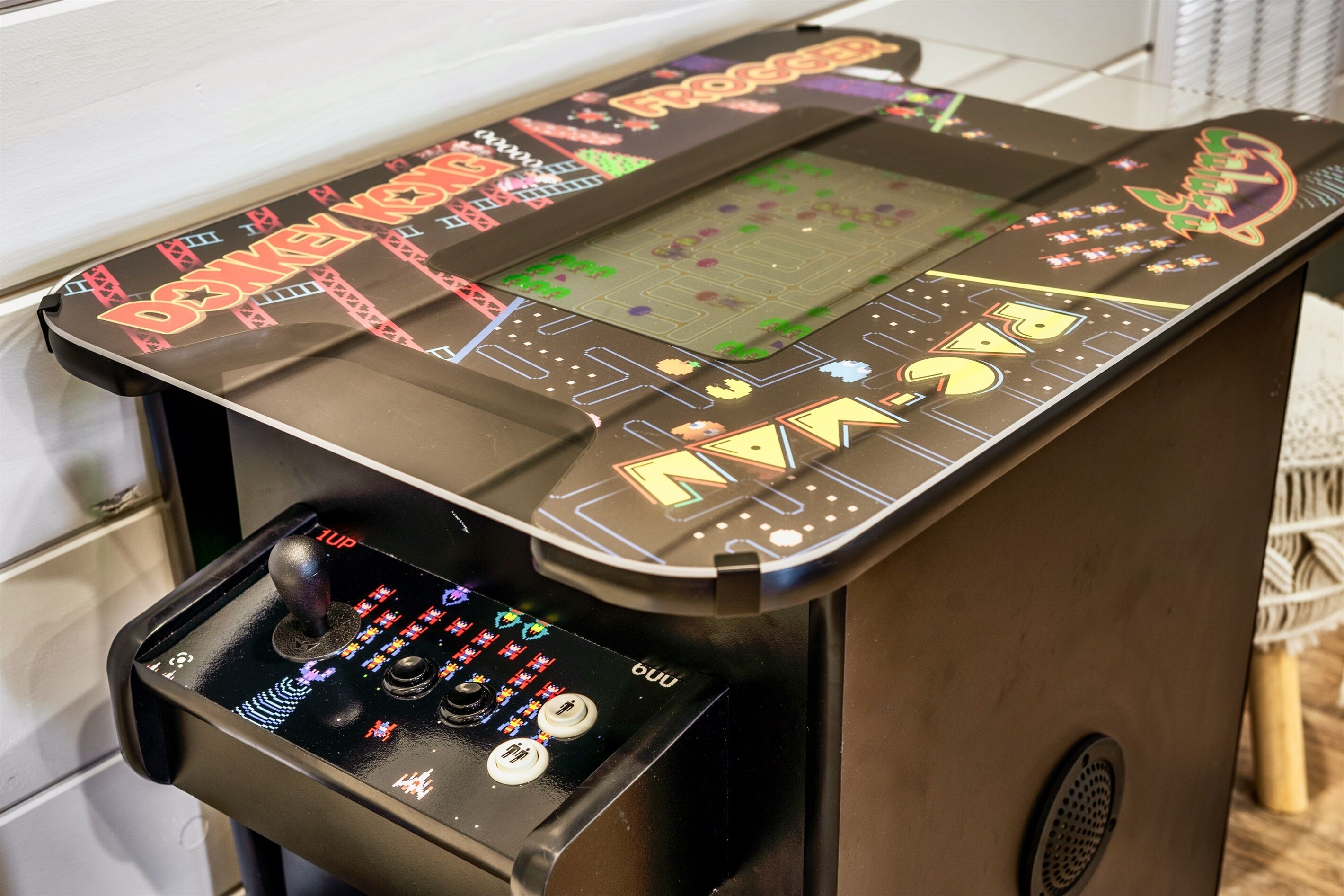 A gaming console with a screen displaying a game, a joystick, and buttons.