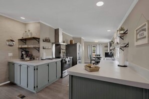 Fridge, microwave, coffee/tea maker, cookware/dishes/utensils