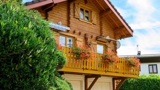 A wooden chalet with a balcony, a satellite dish, and a small shed. - “Our Chalet” with Mountain View, Private Terrace and Wi-Fi (vecoux)
