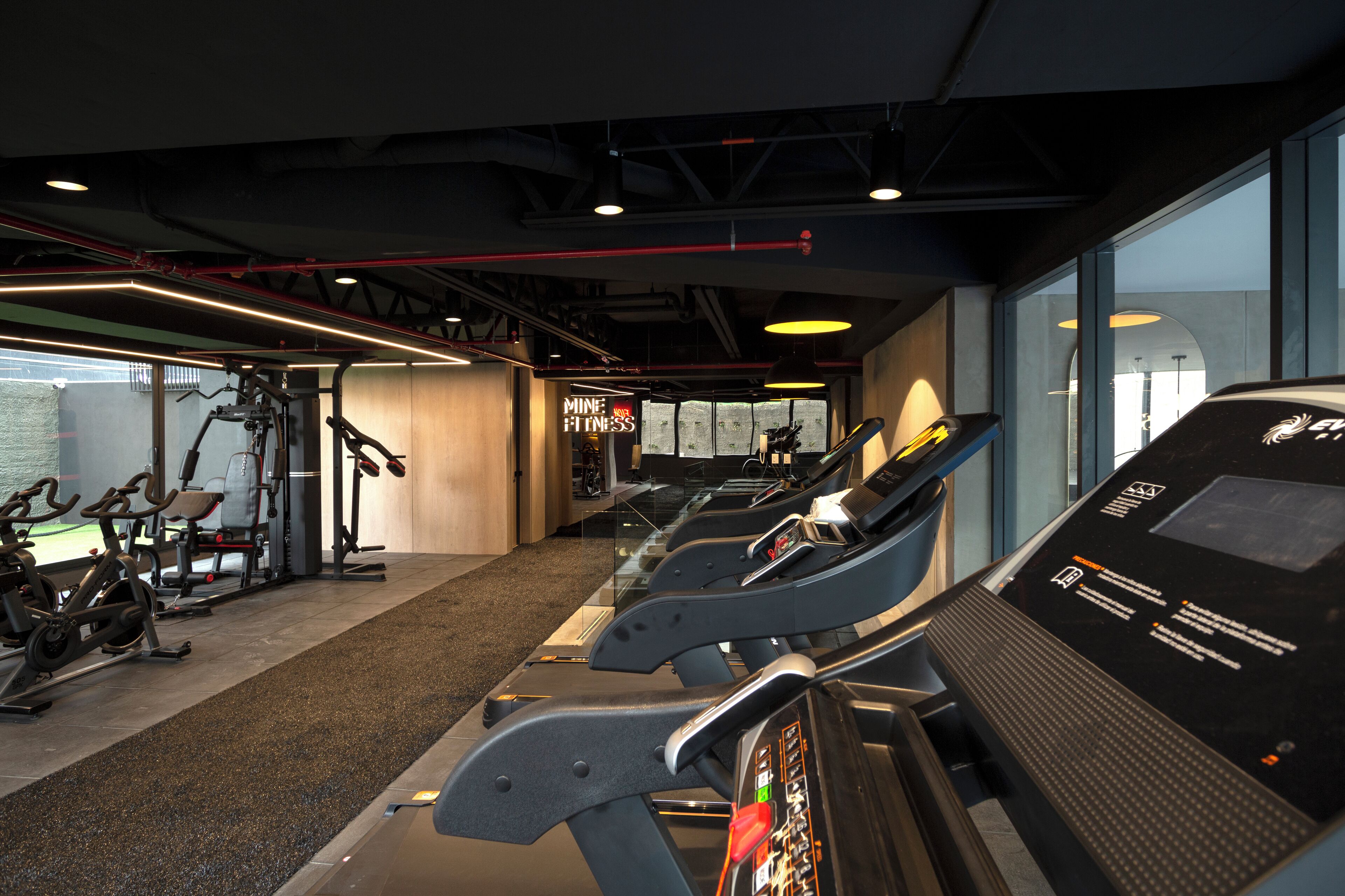 A gym with treadmills, stationary bikes, and weight machines.
