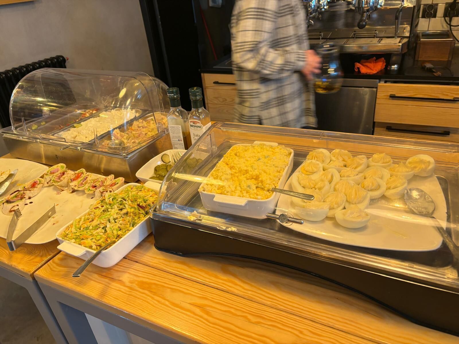 A buffet with various food items including salads, rice dishes, and dumplings.