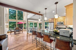 A spacious kitchen with a large island, bar stools, and modern appliances. - Golf Course House w/ Hot Tub, Near Vail & BC (Avon)