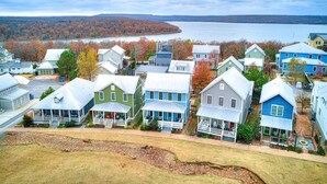 A residential area with houses, a lake, and a distant hill. - Blue Fish on Firefly Park (Carlton Landing)