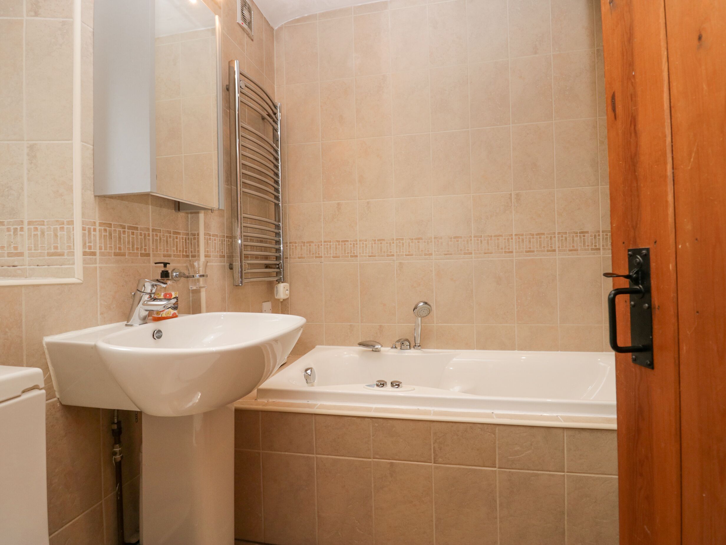 A bathroom with a sink, a toilet, and a bathtub.