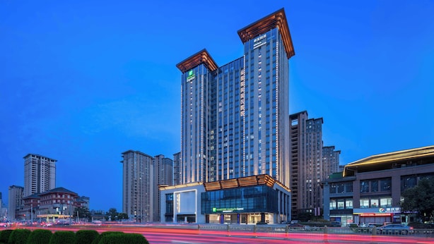 A high-rise hotel with multiple floors, large windows, and a prominent entrance. - Holiday Inn Express Xi An Daxing by IHG (Xi'an)