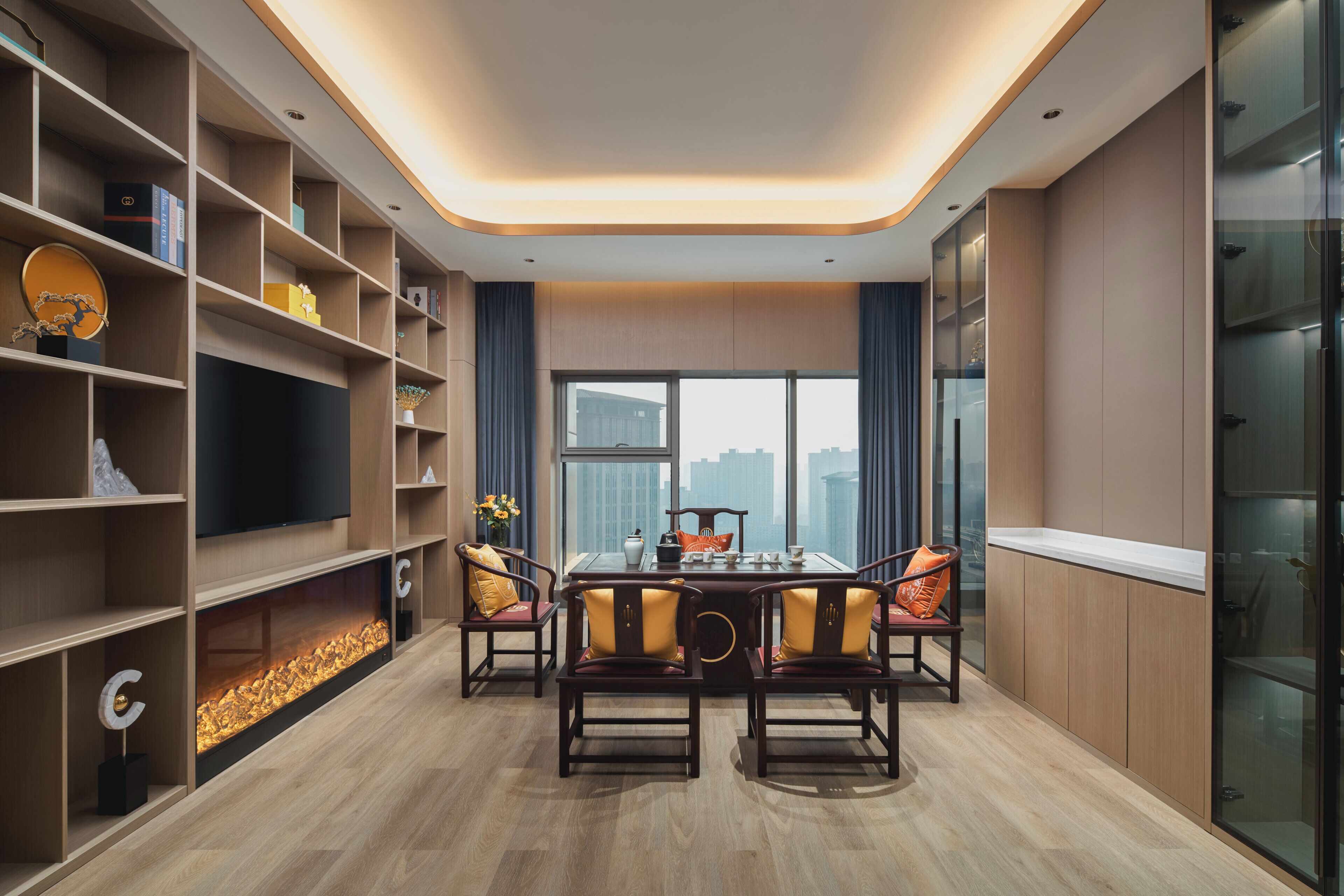 A modern dining area with a table set for four, surrounded by wooden chairs with cushions.