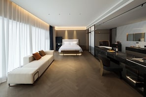 A modern hotel room with a large bed, a sofa, a dining area, and a large window with curtains. - voco Xi'An Qindu Legend by IHG (Xi'an)