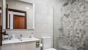 A bathroom with a sink, toilet, and shower. - White Rabbit I by Madeira Sun Travel (Calheta)