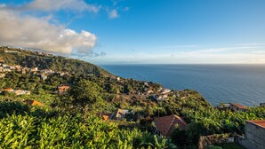 A coastal village with houses on a hillside, overlooking the sea. - White Rabbit I by Madeira Sun Travel (Calheta)