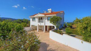 A modern two-story house with a red-tiled roof, white exterior walls, and a covered patio area. - 4 Bedroom Villa, Private Pool, Latchi, Cyprus (Latchi)