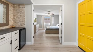 A bedroom with a bed, a ceiling fan, and a view of the outside. - 4 Bed Mid Century Modern w/ Pool, Putting Green, Wood Fired Pizza Oven, Sleeps 9 (Phoenix)