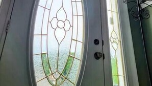 A gray door with a frosted glass panel featuring a geometric design. - Freshly updated house with a clean and spacious feel.( 3 bdr 3 bath 9 ppl.) (Long Pond)