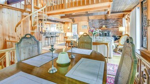 A spacious wooden interior with a dining area, a kitchen, and a staircase. - Charming Tamworth Cabin w/ Grill & Fireplace (Tamworth)