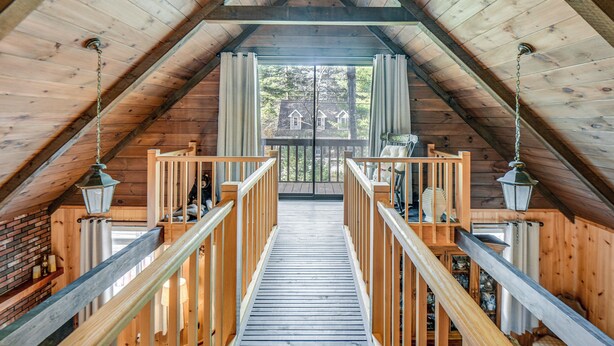 A wooden staircase leading to a balcony with a view of a house. - Charming Tamworth Cabin w/ Grill & Fireplace (Tamworth)