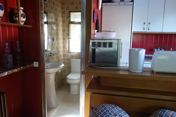 A compact kitchen with a sink, toilet, and a refrigerator. - Suyoluce, Chalet con Piscina Privada El Escorial (El Escorial)