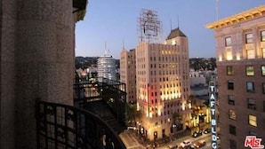 A cityscape with a prominent building labeled "TAFTBLDG" and another building under construction with scaffolding.