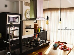 Deluxe Apartment, Beach View | Private kitchen | Fridge, cookware/dishes/utensils, dining tables