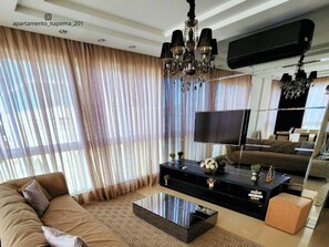 Deluxe Apartment, Beach View | Living area | 45-inch Smart TV with digital channels, Netflix, pay movies